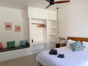 a bedroom with a bed with two pairs of shoes on it at U PARADISU VILLAS - Private Pool in Jambiani