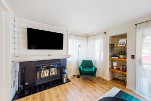 a living room with a fireplace with a tv above it at Fun In the Sun Valley in Sun Valley