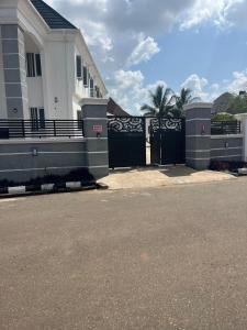 a black gate in front of a house at House One Apartment in Akure
