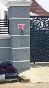 a house one ir sign on the side of a building at House One Apartment in Akure +2 photos
