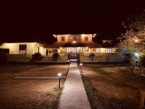 a house at night with lights in front of it at Padmalayam Heritage Villa in Mānantoddy