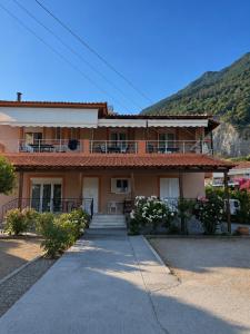 a house with a mountain in the background at PNOÉ rooms in Ilia