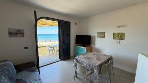 a dining room with a table and a view of the ocean at Appartamenti Lungomare Via Roma in Castiglione della Pescaia