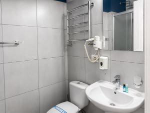a small bathroom with a toilet and a sink at Comfort Hotel in Odesa