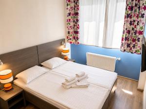a bedroom with a bed with towels on it at Comfort Hotel in Odesa +10 photos