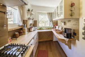 a small kitchen with a stove and a sink at CiasaToa in Cortina dʼAmpezzo
