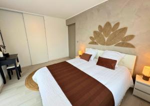 a bedroom with a large bed and a desk at VILLA LÉMAN - Panoramic lake view in Évian-les-Bains
