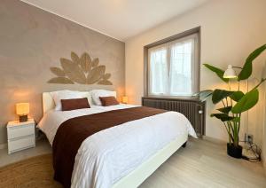 a bedroom with a large bed and a window at VILLA LÉMAN - Panoramic lake view in Évian-les-Bains