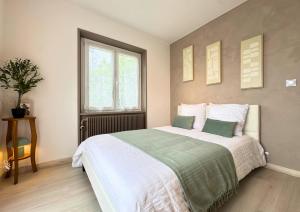 a bedroom with a large bed and a window at VILLA LÉMAN - Panoramic lake view in Évian-les-Bains