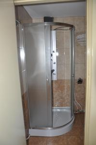 a shower with a glass door in a bathroom at Holiday Home near sea in Odesa