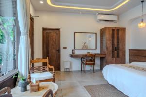 a bedroom with a bed and a desk at Villa Lumora Maldives in Rasdhoo +51 photos