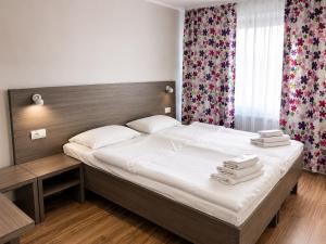 a bedroom with a large bed with towels on it at Mare nero in Odesa
