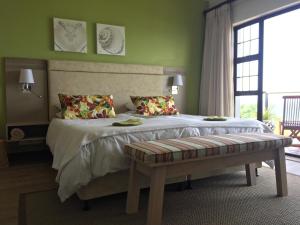a bedroom with a large bed with a large window at Classical View Guesthouse in Mossel Bay