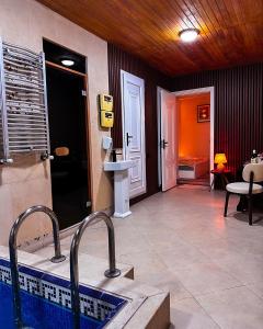 a bathroom with a sink and a swimming pool at White House SPA Hotel in Baku +13 photos