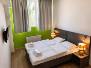 a bedroom with a large bed with a green wall at Mare nero in Odesa