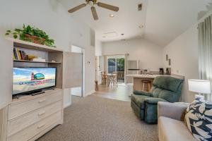 a living room with a flat screen tv and a couch at Chris Cottage 1 in Chincoteague