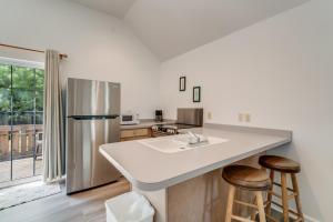 a kitchen with a sink and a refrigerator at Chris Cottage 1 in Chincoteague