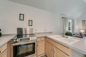 a kitchen with a stove and a sink at Chris Cottage 1 in Chincoteague +9 photos