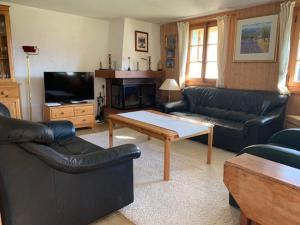 a living room with couches and a coffee table at Chalet Castor in Les Diablerets