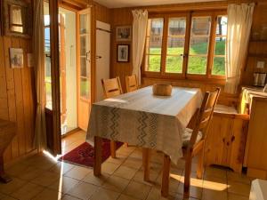 a kitchen with a table and chairs in a room at Chalet Castor in Les Diablerets