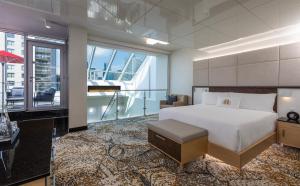 a hotel room with a bed and a balcony at Le Mount Stephen in Montreal