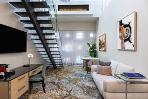 a living room with a couch and a staircase at Le Mount Stephen in Montreal