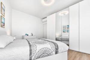 a white bedroom with white walls and a large bed at Sand Beach House - Host Solution in Cavallino-Treporti +32 photos