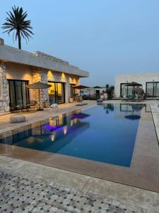 a swimming pool in front of a house at Tempo Vegan B&B in Essaouira