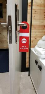 a do not disturb sign on the door of a bathroom at Eurobushi Hotel in Kolgecaj