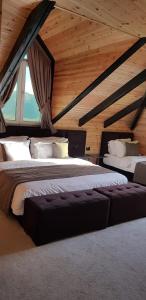 a bedroom with two beds in a attic at Eurobushi Hotel in Kolgecaj +8 photos