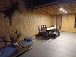 a room with a couch and a table and chairs at Мисливський Дворик in Solochyn