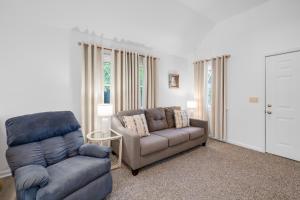 a living room with a couch and a chair at Chris Cottage 3 in Chincoteague