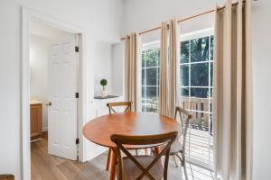 a dining room with a wooden table and a window at Chris Cottage 3 in Chincoteague