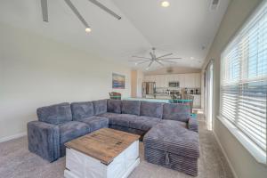 a living room with a blue couch and a table at Dock Holiday in Greenbackville