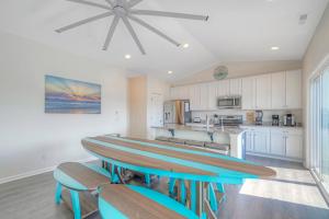 a kitchen with a table with two surfboards on it at Dock Holiday in Greenbackville +46 photos