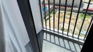 a window with a view of a yard at Azure Suite Apartment - AOSIS in Bagam