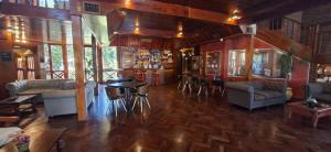 a living room with couches and tables and a bar at Hotel Domus Auditorium Suites in Villa Carlos Paz