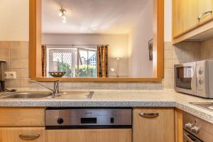 a kitchen with a sink and a microwave at 50081... in Carolinensiel