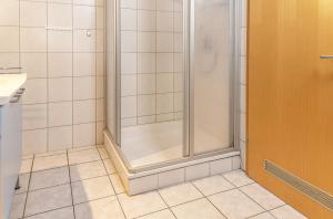 a shower with a glass door in a bathroom at 50081... in Carolinensiel +4 photos