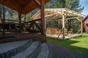 a pavilion with a table and chairs under it at Domki całoroczne u Greściaków in AdamÃ³w