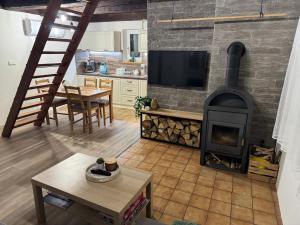 a living room with a fireplace and a stove at Hygge Pržno in Pržno