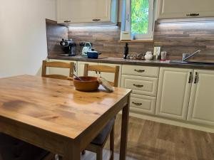 a kitchen with a wooden table with a bowl on it at Hygge Pržno in Pržno