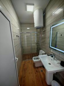 a bathroom with a sink and a shower and a toilet at White apartments in Ulcinj +32 photos