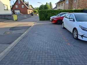 two cars parked next to each other on a street at Penthouse Vue Panoramique in Mechernich