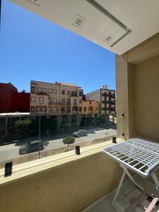 a bed in front of a window with a view of a city at Résidence Maryam in Nador