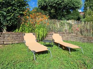 three benches sitting in the grass in a garden at Al Vecchio Lavatoio - Relax in collina in Colle Brianza