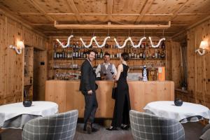 a man and a woman standing at a bar at Hotel Spol - Adults only in Livigno +51 photos