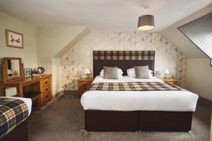 a bedroom with a large bed in a room at Inn at Port nan Gael in Pennyghael