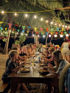 a group of people sitting at a long table at Surf & Turf in Arugam Bay +39 photos