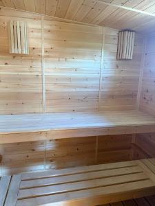 a sauna with a wooden paneled wall at 'Белый дом' in Balqash +1 photo